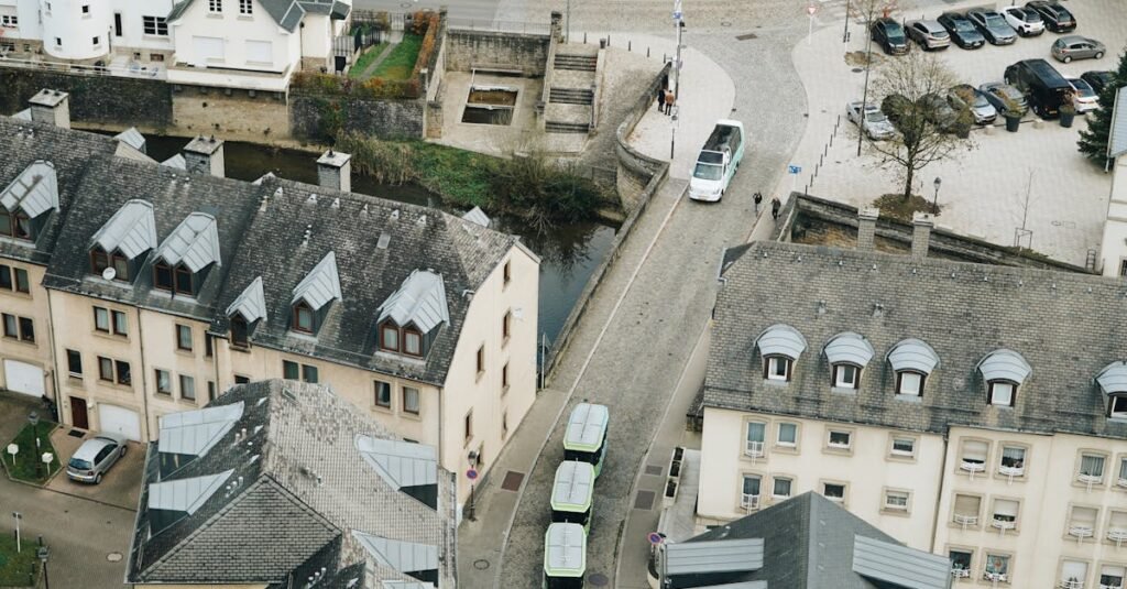 A charming aerial view of a European town with a church and cobblestone streets, showcasing medieval architecture.